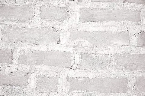 Light gray background from bricks of irregular shape. Stock Photos
