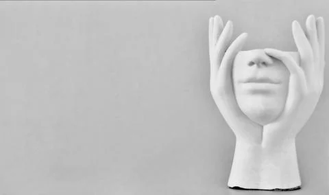 On the light gray background to the right stands a gypsum statuette without the Stock Photos