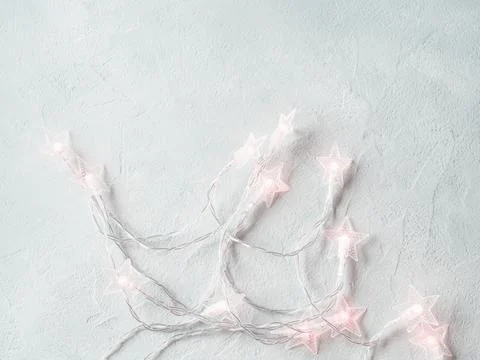 Light gray background with star shape Christmas lights string Stock Photos