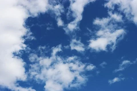 Light gray clouds against a blue sky. Stock Photos