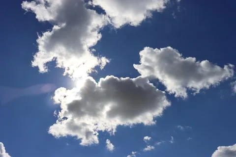 Light gray clouds against a blue sky. Stock Photos