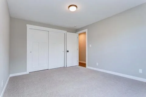 Light gray empty room with white closet. Stock Photos