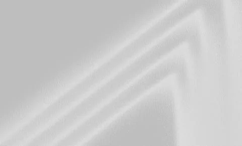 Light gray texture background with soft diagonal light forming a geometric 库存照片