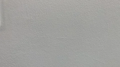 Light gray textured wall surface offers neutral background Stock Photos