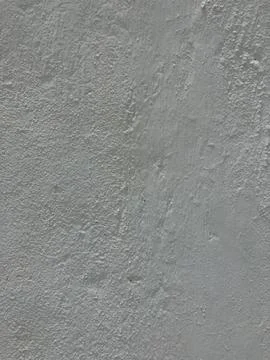 Light gray textured wall surface with brush strokes and bumps Stock Photos