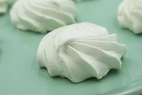 Light green apple marshmallows on a light green plate, close-up Stock Photos