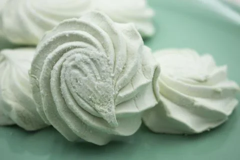 Light green apple marshmallows on a light green plate, close-up Stock Photos