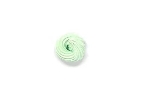 Light green bize, multi-colored sweets, airy cakes on isolated white backgrou Stock Photos