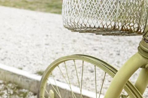 Light-green colored Bicycle without tires with white iron basket on a backgro Stock Photos