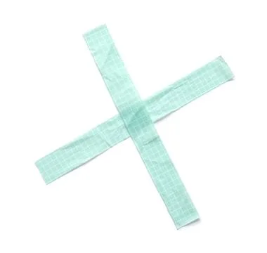 Light green grid patterned adhesive tape forming an x shape, isolated on a cl Stock Photos