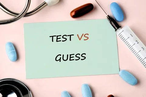 Light green note displays test versus guess text Fotos Stock