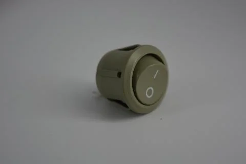 Light green plastic button for electronics, electrical engineering, electrics. Stock Photos