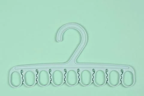 Light Green Plastic Multi Clip Hanger on Matching Background Stock Photos