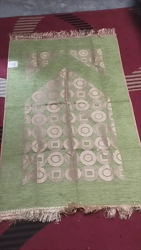 The light green prayer mat is very nice Stock Footage 293056624