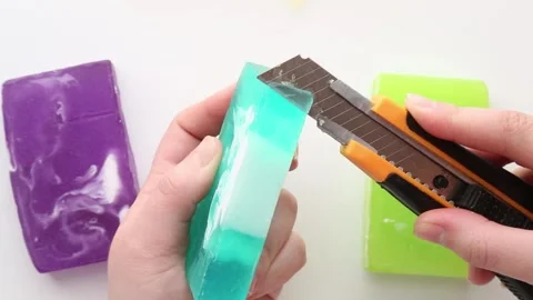 Light green soap blocks cut into uneven fragments with a knife, showcasing a Stock Footage 311060635