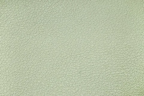 Light green textured surface background with subtle bumps and irregular patte Stock Photos