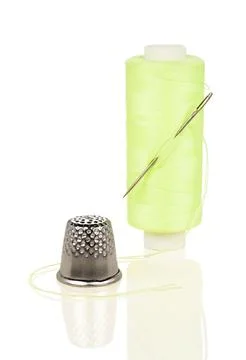 Light Green Thread Spool with Needle and Thimble Close-up Isolated Stock Photos