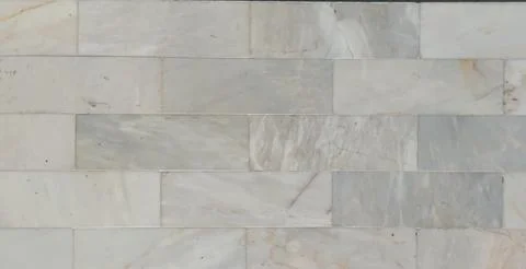 ​Light grey and white marble subway tile wall texture background. Stock Photos