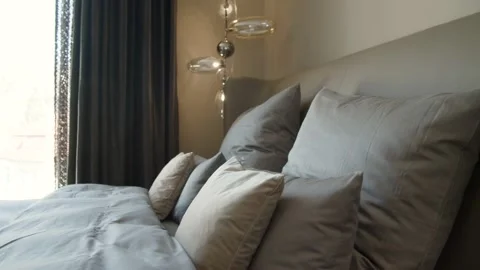 Light Grey Bed with Pretty Pillows in a Bedroom  Stock Footage 131959419