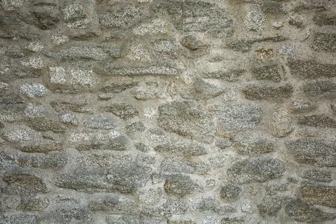 A light grey, medieval stone wall background. Stock Photos