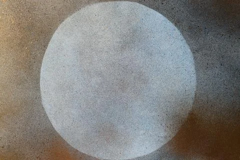 Light grey textured background covered with golden spray paint and circle lef Stock Photos