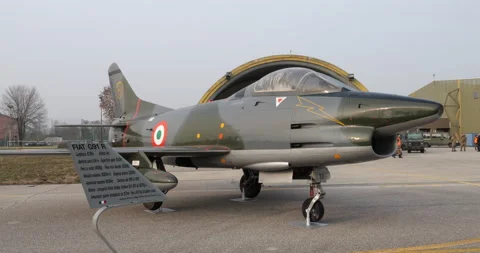 Light ground attack jet aircraft of Cold War in green mimetic camouflage parked 動画素材 235463328