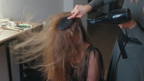 Light hairspray sets the style, securing the transformation Stock Footage 308468909