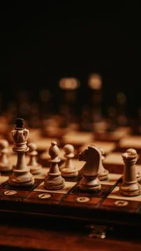 Light half of a chess board with chess pieces ready to play Stock Photos