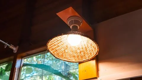 A light is hanging from the ceiling and is lit up Stock Photos