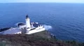 Light house on cliff stands over the calm sea on Isle of Man HD Footage