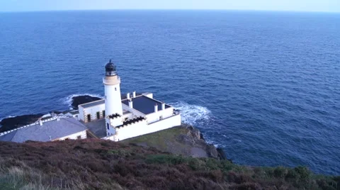 Light house on cliff stands over the calm sea on Isle of Man Stock Footage 52181186