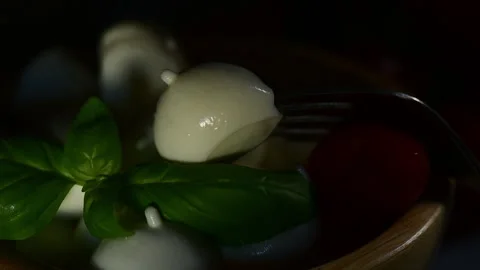 Light illuminates fresh apulian mozzarella cheese in a wooden bowl Stock Footage 153271994