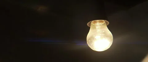 Light of incandescent light globe in the dark 5.7K anamorphic video Stock Footage 304686375