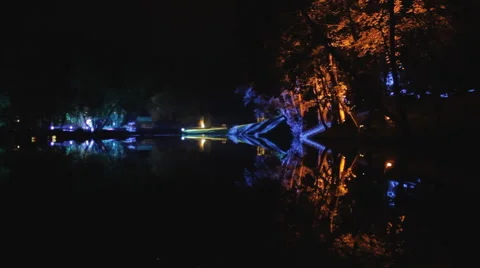 Light installation next to lake at night Видео 57962576