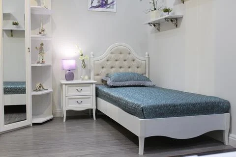 Light interior with a single bed for the bedroom Stock Photos