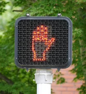 A light at an intersection indicating it is not safe to cross Stock Photos