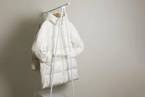 Light jacket on a floor rack on a neutral background Foto stock