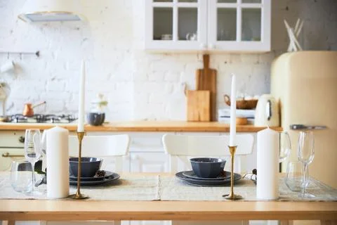 Light kitchen in the style of loft, preparation for the holiday, served table Stock Photos