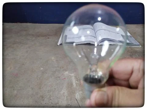 Light of knowledge in the book Stock Photos