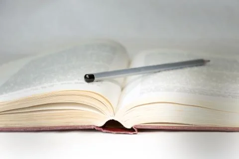 Light of knowledge is an open book close-up, illuminated by ray of light. Stock Photos