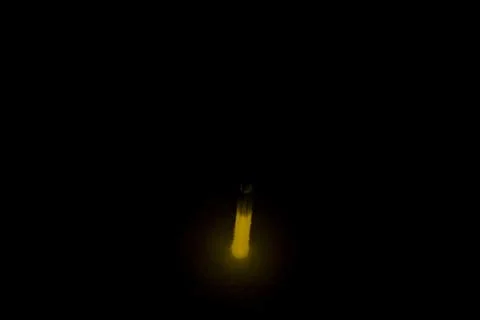 The light of the lamp on a black background in the dark. Stock Photos