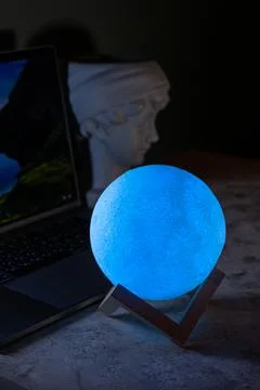 Light the lamp on the desktop. A modern table lamp illuminates the background Stock Photos