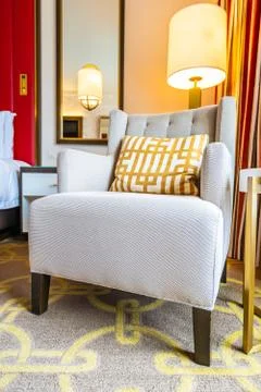Light lamp on table side with pillow and sofa Stock Photos