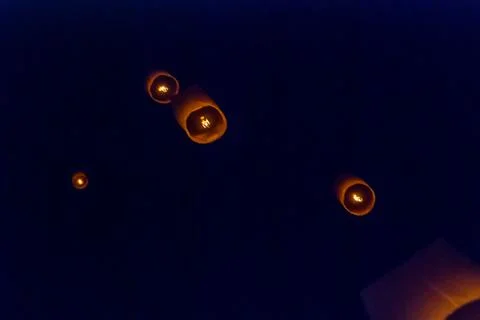 Light up lanterns flying to the sky at night Stock Photos