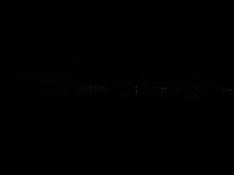 Light of the lanterns of the night city is reflected in the river. Stock Photos