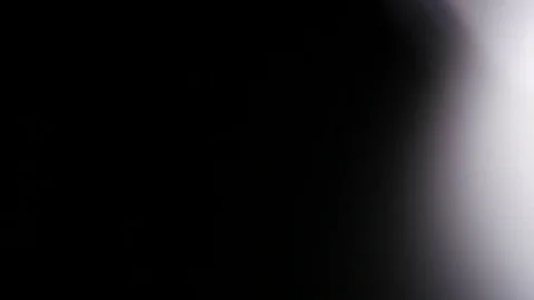 Light leak in 4K quality on dark background with.Real lens flare Stock Footage 81342534