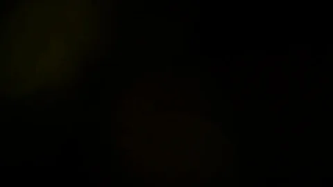 Light leak in 4K quality on dark background with.Real lens flare Stock Footage 81380098