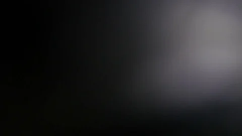 Light leak in 4K quality on dark background with.Real lens flare Stock Footage 81380575