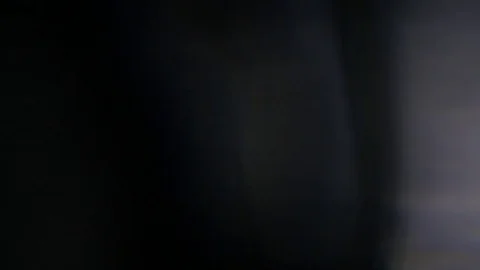 Light leak in 4K quality on dark background with.Real lens flare Stock-Footage 81410615