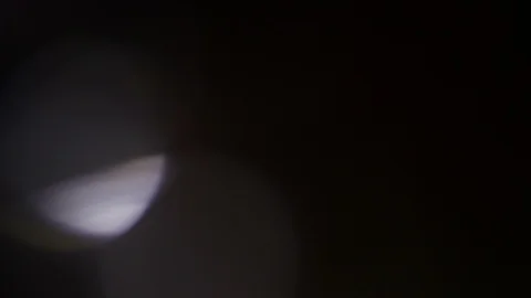 Light leak in 4K quality on dark background with.Real lens flare Stock Footage 86684854